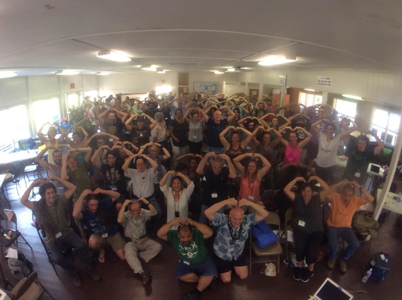 KNF community making heart shapes with their hands